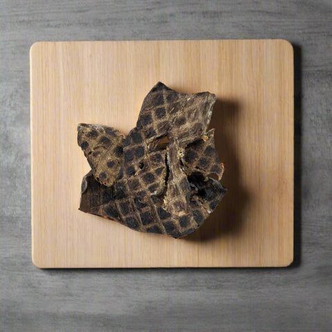 Pieces of beef Jerky pet treat on chopping board