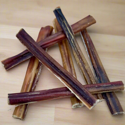 Collection of beef pizzles on a chopping board