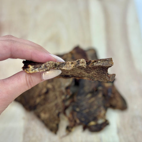 Piece of Emu Jerky shown held in hand