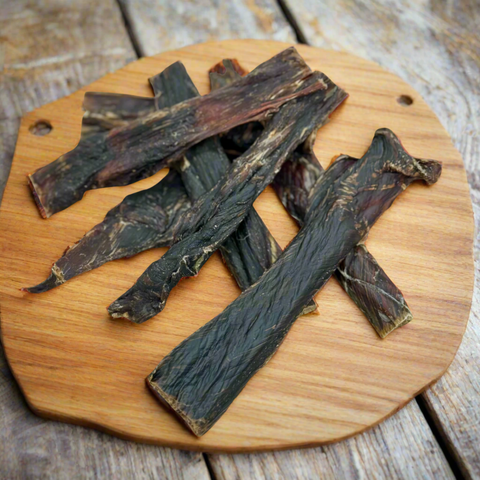 Kangaroo Jerky Strips for dogs shown on a chopping board