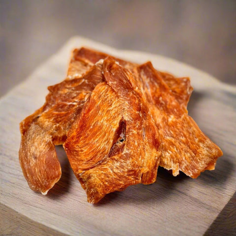 Air-dried Chicken Jerky shown on a chopping board