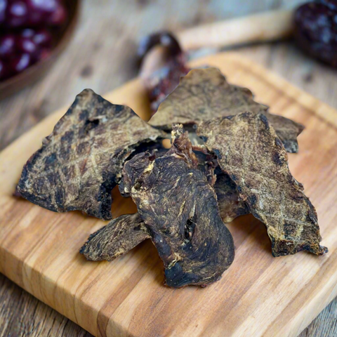 Air-dried Emu Jerky for dogs shown on a chopping block