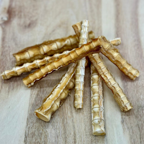 Pieces of Shark Cartilage Treat for dogs presented on a wooden chopping board