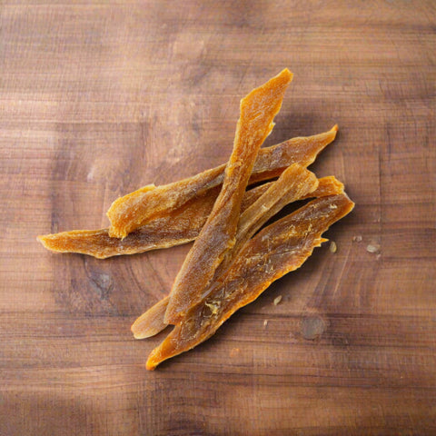 Pieces of Shark Jerky pet treat on chopping board